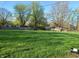 Wide view of backyard with mowed grass and foliage at 2315 E 3Rd St, Anderson, IN 46012
