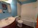 Modest bathroom features a shower-tub combo, toilet, and a single sink vanity at 2315 E 3Rd St, Anderson, IN 46012