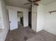 Bedroom view featuring a ceiling fan, a closet, and an adjoining room at 2315 E 3Rd St, Anderson, IN 46012