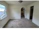 Dining area featuring a vintage carpet, a window, and an arched doorway to the kitchen at 2315 E 3Rd St, Anderson, IN 46012
