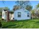A view of the side of the home showcasing vinyl siding and highlighting its architectural details and yard at 2315 E 3Rd St, Anderson, IN 46012