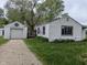 Exterior featuring a detached garage with a gravel driveway at 2315 E 3Rd St, Anderson, IN 46012