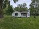 Charming single-Gathering home with green lawn, mature trees, and a welcoming front entrance at 2315 E 3Rd St, Anderson, IN 46012