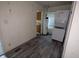 A compact laundry area features a washer-dryer combo, water heater and vinyl floors at 2315 E 3Rd St, Anderson, IN 46012