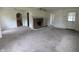 Living room with brick fireplace, arched doorway, and neutral carpet at 2315 E 3Rd St, Anderson, IN 46012