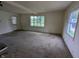 Bright living room with neutral walls, large windows, and a view of the outdoors at 2315 E 3Rd St, Anderson, IN 46012