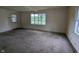 Large living room boasts lots of natural light and wall-to-wall carpeting at 2315 E 3Rd St, Anderson, IN 46012