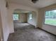 Cozy living room boasts lots of natural light, neutral paint and wall-to-wall carpet at 2315 E 3Rd St, Anderson, IN 46012