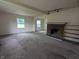 Large living room features a brick fireplace, lots of natural light and wall-to-wall carpet at 2315 E 3Rd St, Anderson, IN 46012