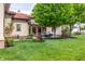 Manicured backyard featuring a lush lawn, mature trees, and patio area at 2377 Finchley Rd, Carmel, IN 46032