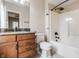Bathroom featuring a tub/shower combination and granite vanity with wood cabinets at 2377 Finchley Rd, Carmel, IN 46032