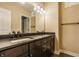 Double vanity in the bathroom with dark cabinetry and modern fixtures at 2377 Finchley Rd, Carmel, IN 46032