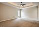 Expansive empty bedroom with neutral carpeting, a tray ceiling, and ample natural light at 2377 Finchley Rd, Carmel, IN 46032