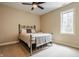 Cozy bedroom features a ceiling fan, neutral walls and carpet, and natural light from the window at 2377 Finchley Rd, Carmel, IN 46032