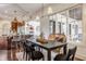 Open concept dining room with elegant furniture and an adjacent view of the kitchen at 2377 Finchley Rd, Carmel, IN 46032