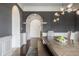 Elegant dining room with a modern chandelier, view of archways to other rooms, and stylish wood flooring at 2377 Finchley Rd, Carmel, IN 46032