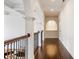 Bright hallway with elegant arches, hardwood flooring, and decorative ceiling details at 2377 Finchley Rd, Carmel, IN 46032