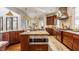 Open concept kitchen features a center island with bar seating and stainless steel Wolf appliances at 2377 Finchley Rd, Carmel, IN 46032