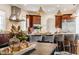Bright kitchen featuring wooden cabinetry, stainless steel appliances, pendant lighting, and a center island with bar stool seating at 2377 Finchley Rd, Carmel, IN 46032