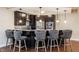 Modern kitchen island with counter seating, pendant lighting, and stainless steel appliances at 2377 Finchley Rd, Carmel, IN 46032
