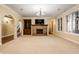 Bright living room boasting a stone fireplace, built-in bookshelves, and large windows at 2377 Finchley Rd, Carmel, IN 46032