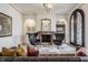 Cozy living room featuring a fireplace, ornate mirror, decorative lighting, and stylish furnishings at 2377 Finchley Rd, Carmel, IN 46032