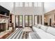 Spacious living room with fireplace, built-in shelves, large glass doors, and hardwood floors at 2377 Finchley Rd, Carmel, IN 46032