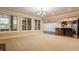 Spacious living room featuring large windows, carpet floors, and an open layout to the kitchen at 2377 Finchley Rd, Carmel, IN 46032