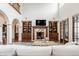 Bright living room with fireplace, built-in shelves and a view of a second floor balcony at 2377 Finchley Rd, Carmel, IN 46032