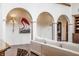 Elegant living room featuring high ceilings and arched doorways with a flamingo painting at 2377 Finchley Rd, Carmel, IN 46032