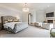 Spacious and bright main bedroom features a cozy fireplace, sitting area, and luxurious finishes at 2377 Finchley Rd, Carmel, IN 46032