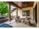 Covered patio with wicker chairs, a ceiling fan, and access to the backyard at 2377 Finchley Rd, Carmel, IN 46032