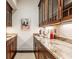 Granite countertops and wooden cabinets in the serving area, along with decorative items and a neutral rug at 2377 Finchley Rd, Carmel, IN 46032