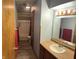 Clean bathroom with a tub and shower, well-lit mirror and a convenient sink with ample counter space at 255 S 900 E, Zionsville, IN 46077