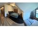 Spacious bedroom with a cozy ambiance, featuring a comfortable bed and natural light from a window at 255 S 900 E, Zionsville, IN 46077