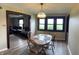 Inviting dining area features a wooden table and chairs, with natural light, creating a perfect gathering space at 255 S 900 E, Zionsville, IN 46077