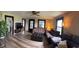 Cozy living room features hardwood floors, a ceiling fan, and ample natural light from the windows at 255 S 900 E, Zionsville, IN 46077