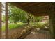 View of the backyard from the covered patio, showing the lawn and trees at 3131 Stillmeadow Dr, Indianapolis, IN 46214