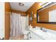 Cozy bathroom with shower-tub combo, framed mirror, and tile flooring at 3131 Stillmeadow Dr, Indianapolis, IN 46214