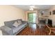 Living room featuring a gray sofa, hard wood floors, and a stone fireplace at 3131 Stillmeadow Dr, Indianapolis, IN 46214