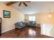 Bright living room with laminate floors, beamed ceilings, neutral walls, and gray sofas at 3131 Stillmeadow Dr, Indianapolis, IN 46214