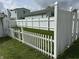Backyard featuring a well-maintained white picket fence and healthy green grass at 318 Elva St, Anderson, IN 46013