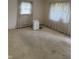 Spacious bedroom with carpet and window with sheer curtains at 318 Elva St, Anderson, IN 46013