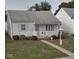 Charming single story home with white siding, walkway and pretty landscaping at 318 Elva St, Anderson, IN 46013