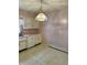Kitchen with classic cabinetry, white appliances, linoleum flooring, and a decorative chandelier at 318 Elva St, Anderson, IN 46013