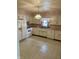 Kitchen featuring white cabinets, appliances, and linoleum flooring, complete with a window and sink at 318 Elva St, Anderson, IN 46013