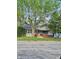 Charming single-story home with a brick porch and mature trees adding character to the property at 3547 N Emerson Ave, Indianapolis, IN 46218