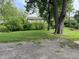 Spacious backyard featuring lush green grass, mature trees, and partial view of house at 3720 E Southern Ave, Indianapolis, IN 46203