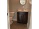 A bathroom featuring a vanity and mirror, and a toilet, all within a compact space at 3720 E Southern Ave, Indianapolis, IN 46203