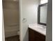 This renovated bathroom includes a large sink, updated vanity, and a mosaic-style mirror at 3720 E Southern Ave, Indianapolis, IN 46203